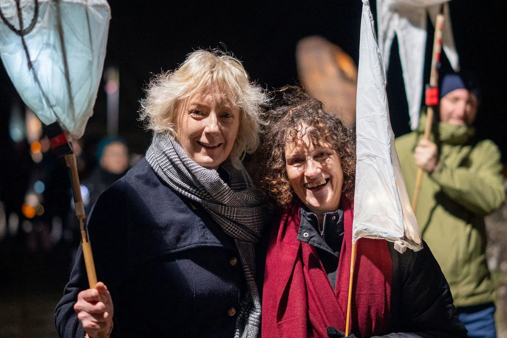Festival attendees holding lanterns at night during Mayo Dark Sky Festival.