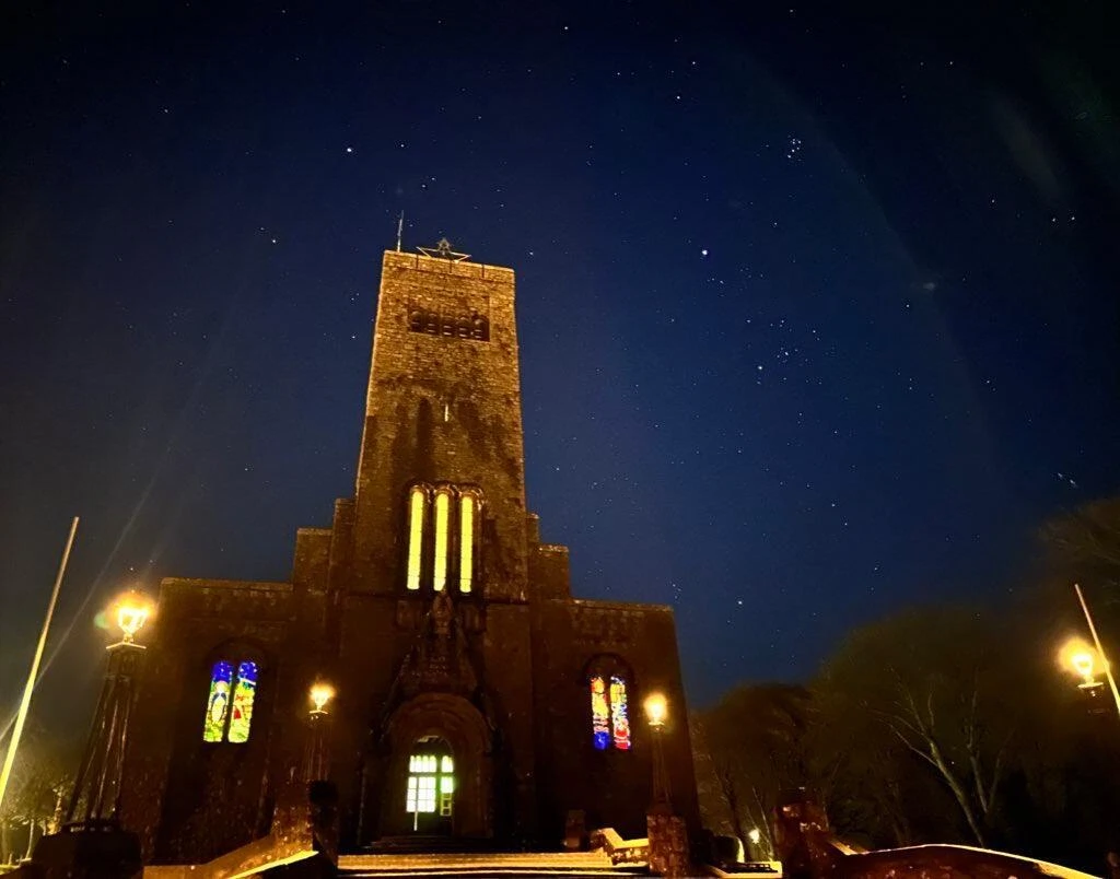 Night sky over historic building at Mayo Dark Sky Festival; starry backdrop enhances festival's celestial focus.