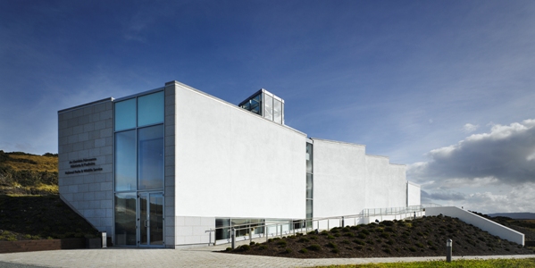 Modern white building under clear sky, suitable for Mayo Dark Sky Festival, showcasing contemporary architecture.