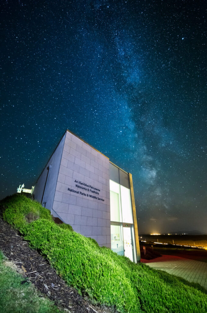 Modern building of National Parks & Wildlife Service under starry night sky, showcasing stargazing beauty.