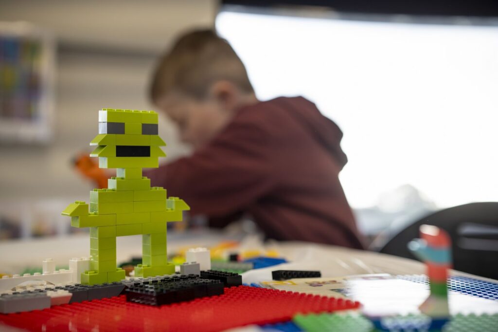 Child building lego character