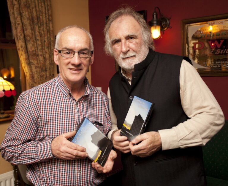 photo of two men holding DVDs